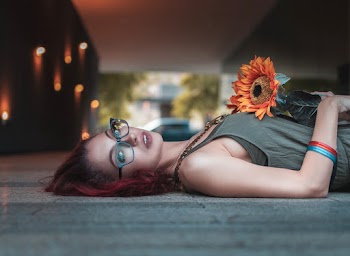 Photo Of Woman Holding Sunflower