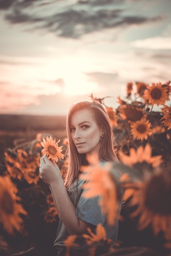 Photo Of Woman Holding Sunflower