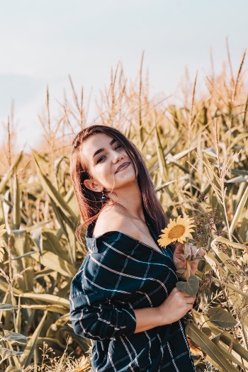 Photo of Woman Holding Sunflower
