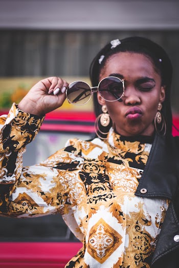 Photo of Woman Holding Sunglasses