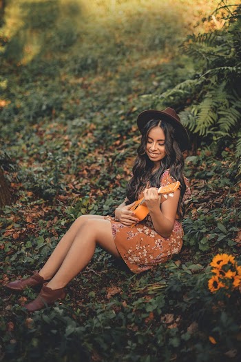 Photo of Woman Holding Ukulele