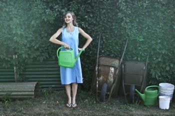 Photo of Woman Holding Watering Can
