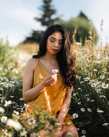 Photo of Woman Holding White Flower