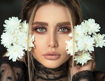 Photo of Woman Holding White Flowers
