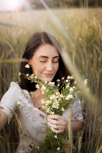 Photo of Woman Holding White Flowers