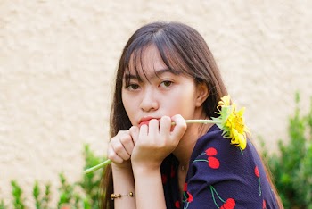 Photo Of Woman Holding Yellow Flower