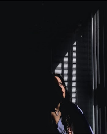 Photo Of Woman In A Dark Room