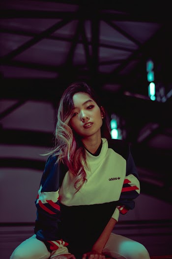 Photo of Woman in Adidas Sweatshirt Posing