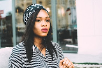 Photo of Woman in Black Bandana and Black and White Striped Top