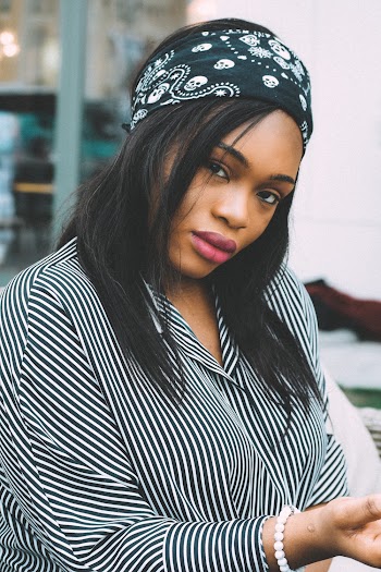 Photo of Woman in Black Bandana and Striped Top