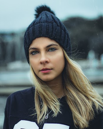 Photo of Woman in Black Beanie Hat and Black Top