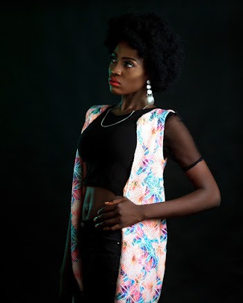 Photo of Woman in Black Crop Top and Floral Sleeveless Cardigan Posing