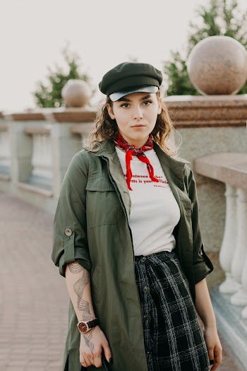Photo of Woman in Black Hat and Neck Scarf Posing