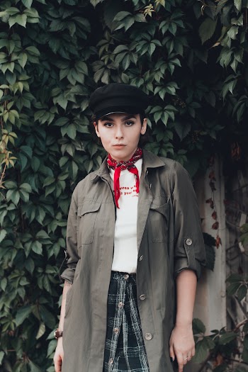 Photo of Woman in Black Hat and Neck Scarf Posing