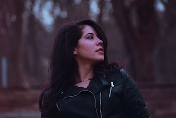 Photo of Woman in Black Leather Jacket Looking Away