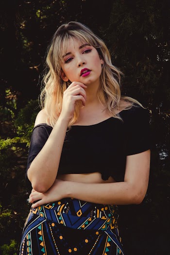 Photo of Woman in Black Off-shoulder Crop-top and Multi-colored Bottoms Posing