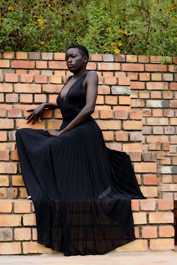 Photo of Woman in Black Sleeveless Dress Posing