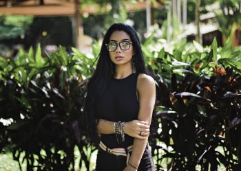 Photo of Woman in Black Sleeveless Top and Sunglasses Standing