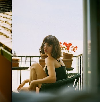 Photo of Woman in Black Spaghetti Strap Top