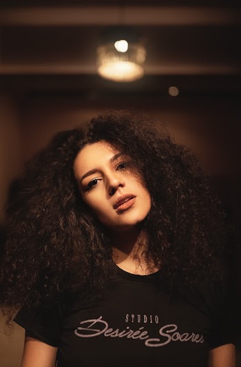 Photo of Woman in Black T-shirt Posing