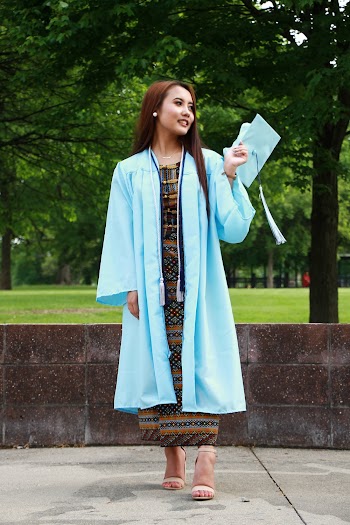 Photo of Woman in Blue Academic Regalia Looking Away