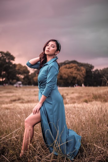 Photo of Woman in Blue Dress Posing With Her Eyes Closed