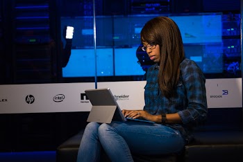 Photo of Woman in Blue Jeans Using Laptop