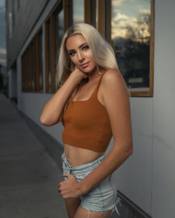 Photo of Woman in Brown Crop Top and Denim Shorts Posing