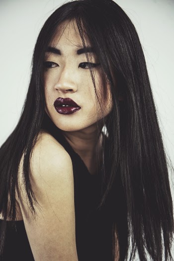 Photo of Woman in Dark Lipstick and a Black Sleeveless Top Posing