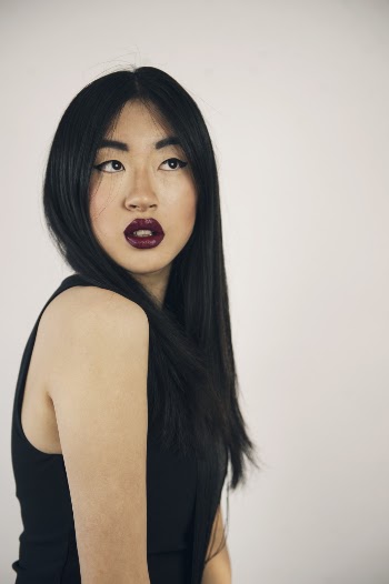 Photo of Woman in Dark Lipstick and a Black Sleeveless Top Posing