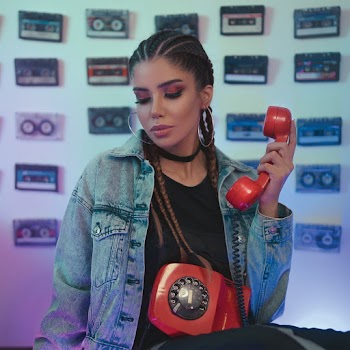 Photo of Woman in Denim Jacket Holding Red Telephone