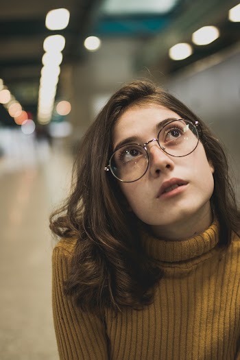 Photo of Woman in Eyeglasses Looking Up