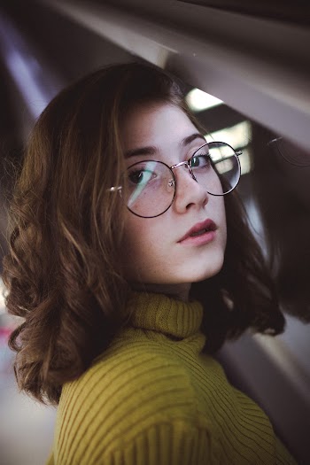 Photo of Woman in Eyeglasses Wearing Yellow Sweater