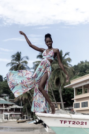 Photo of Woman in Floral Dress Posing on a Boat