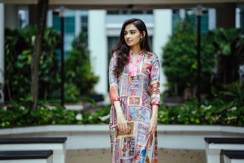 Photo of Woman In Floral Salwar Kameez Posing While Looking Away