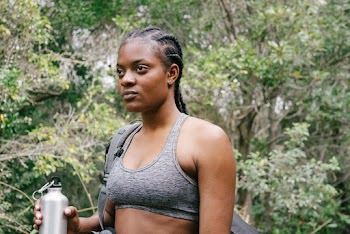 Photo of Woman in Gray Sports Bra Holding Water Bottle