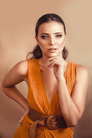 Photo of Woman In Mustard Outfit Posing With Hand on Chin