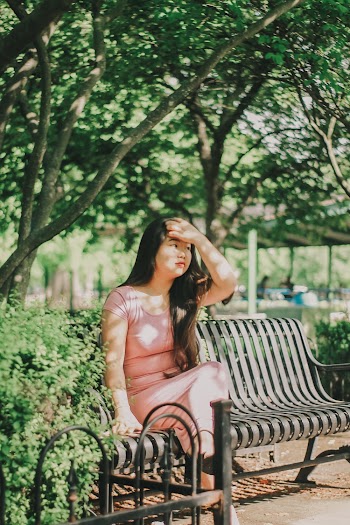 Photo of Woman in Pink Dress Sitting on Park Bench