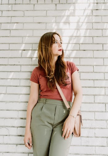 Photo of Woman in Red Top Leaning on Wall