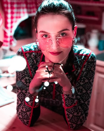 Photo of Woman in Sunglasses Holding String Lights