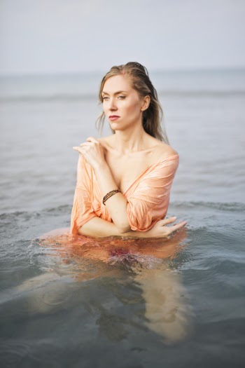 Photo of Woman in Water Wearing Orange Dress