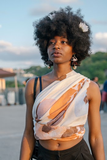 Photo of Woman in White and Brown Crop Top Posing