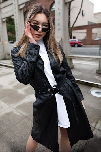 Photo of Woman in White Dress and Black Trench Coat Posing