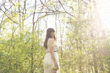 Photo of Woman in White Dress Standing in the Woods Looking Back