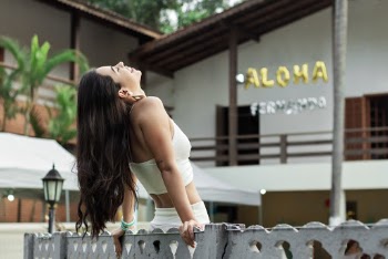 Photo of Woman In White Outfit Leaning Backwards on Wooden Fence