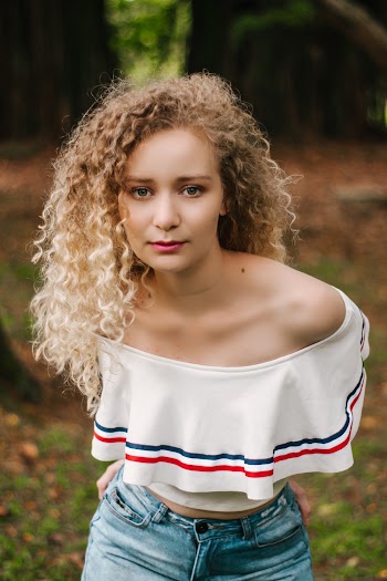 Photo of Woman in White Top and Blue Jeans