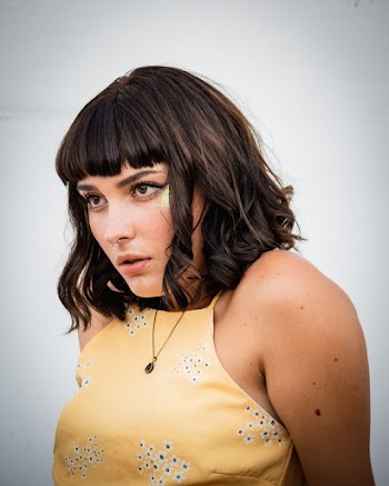 Photo of Woman in Yellow Sleeveless Top Posing