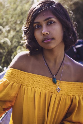 Photo of Woman in Yellow Top Posing