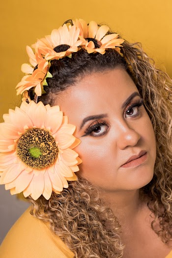 Photo of Woman in Yellow Top With Sunflowers on Her Hair
