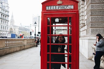 Photo of Woman Inside the Telephone Booth